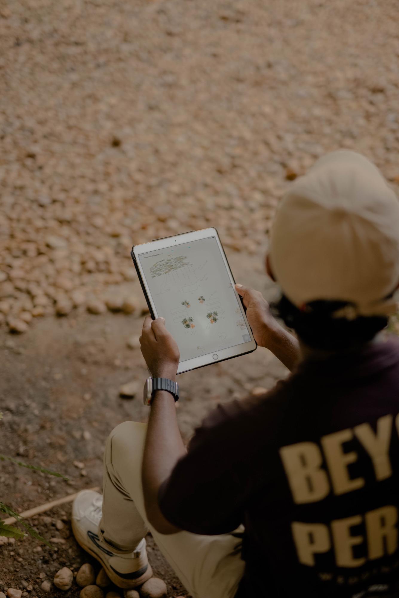Deneth reviewing plans on a tablet