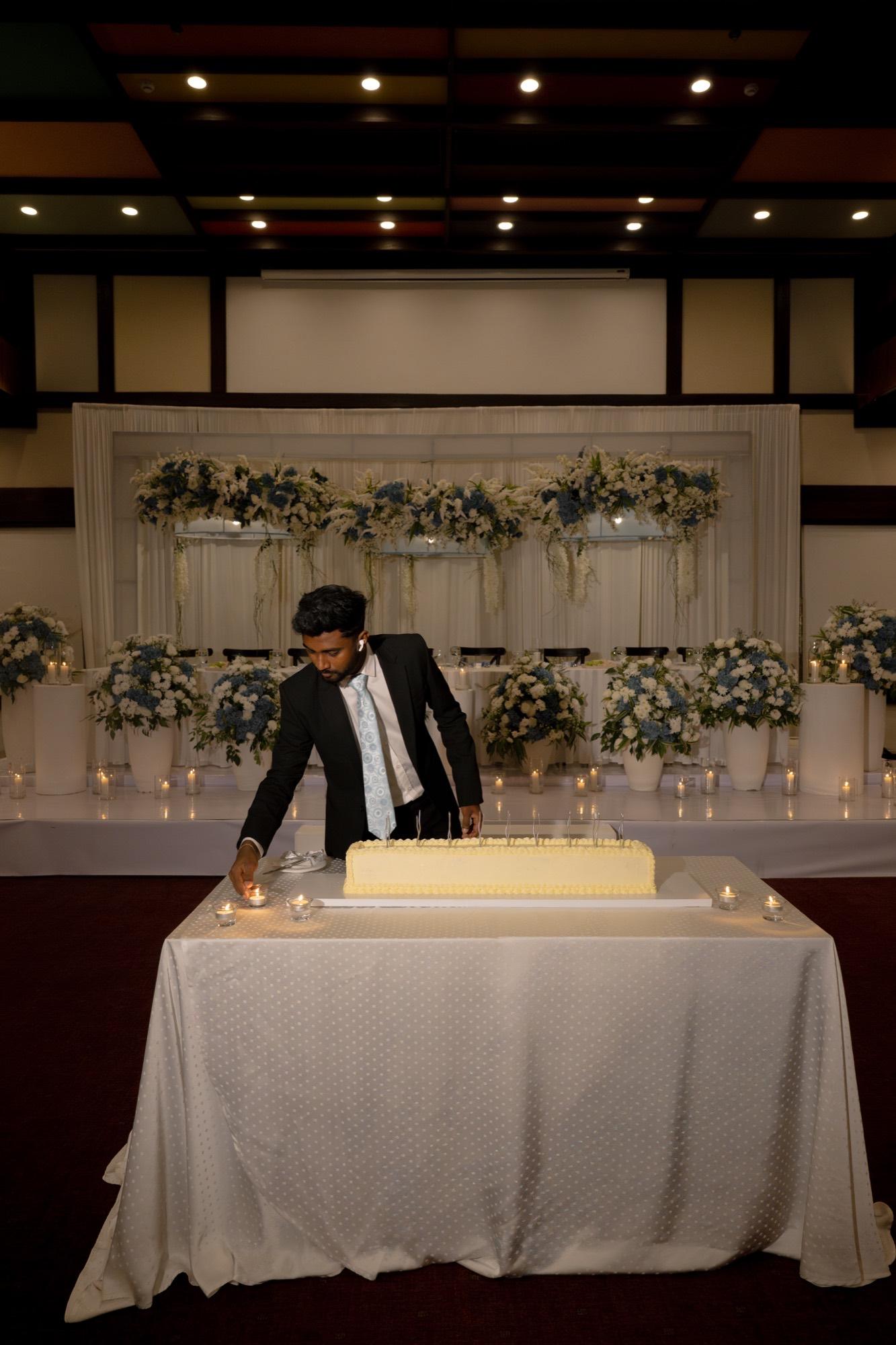 Deneth lighting candles at a wedding setup